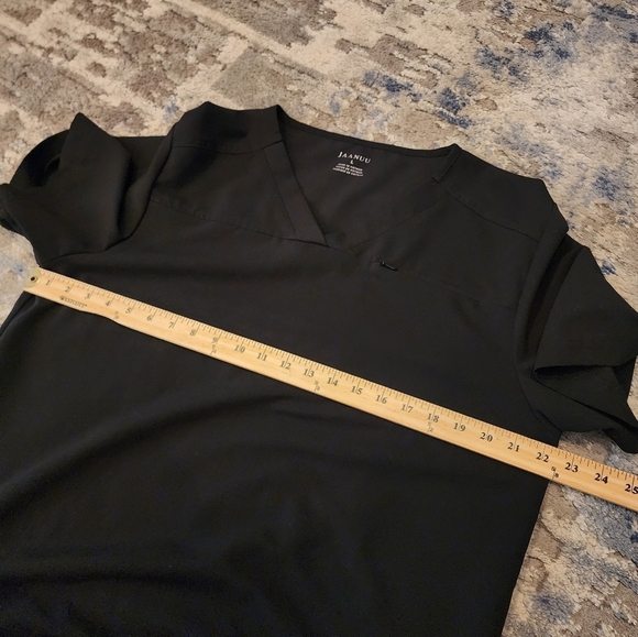 Jaanuu black scrub top. 1 zip chest pocket.  Short sleeve v-neck. Women's size L - Picture 8 of 14